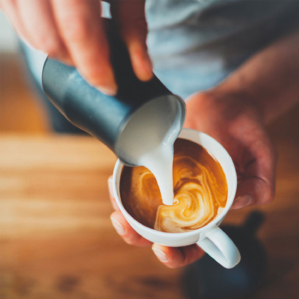 Pouring Creamer in a mug of Segafredo Coffee