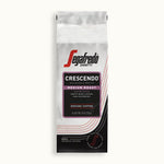 Load image into Gallery viewer, A bag of Segafredo Zanetti® Coffee Crescendo Medium Roast Ground Coffee with tasting notes of sweet black cherry, raspberry, and earthy undertones, weighing 10 oz (283g).

