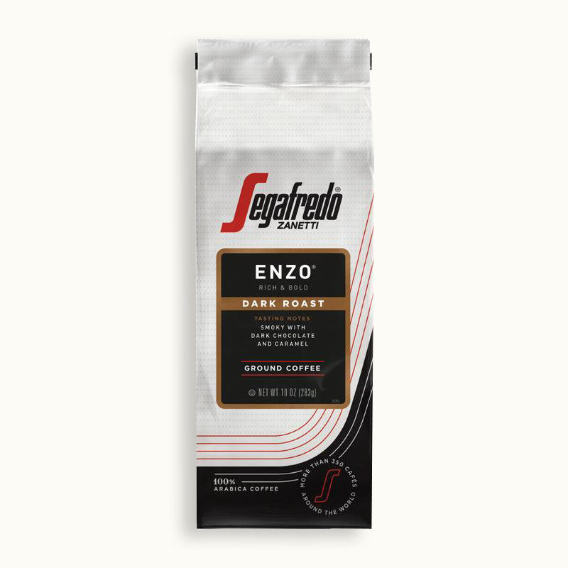 A white coffee bag labeled "Segafredo Zanetti® Coffee Enzo Dark Roast Ground Coffee" with tasting notes of dark chocolate and caramel, featuring a South American blend, weighing 10 oz (283 g).